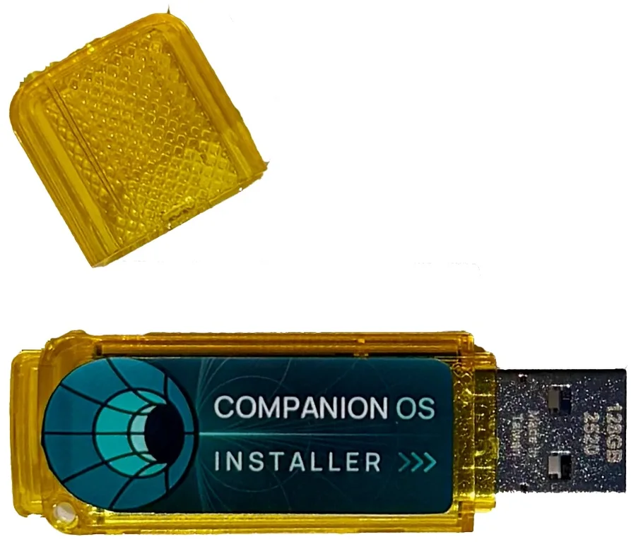Yellow Companion OS installer USB drive with its cap removed.